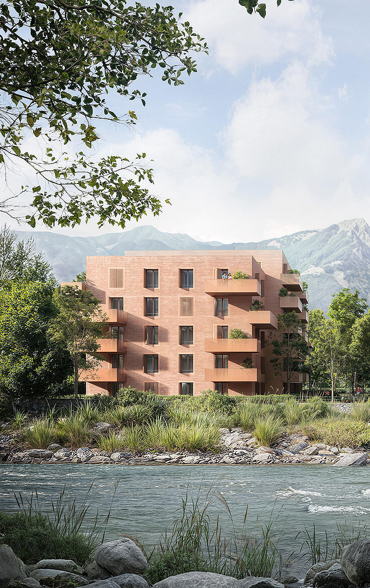 Zwei moderne Wohngebäude am Fluss, umgeben von Bäumen und Bergen im Hintergrund.