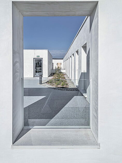 Window detail with deep reveals and glass balustrade at JED Schlieren façade