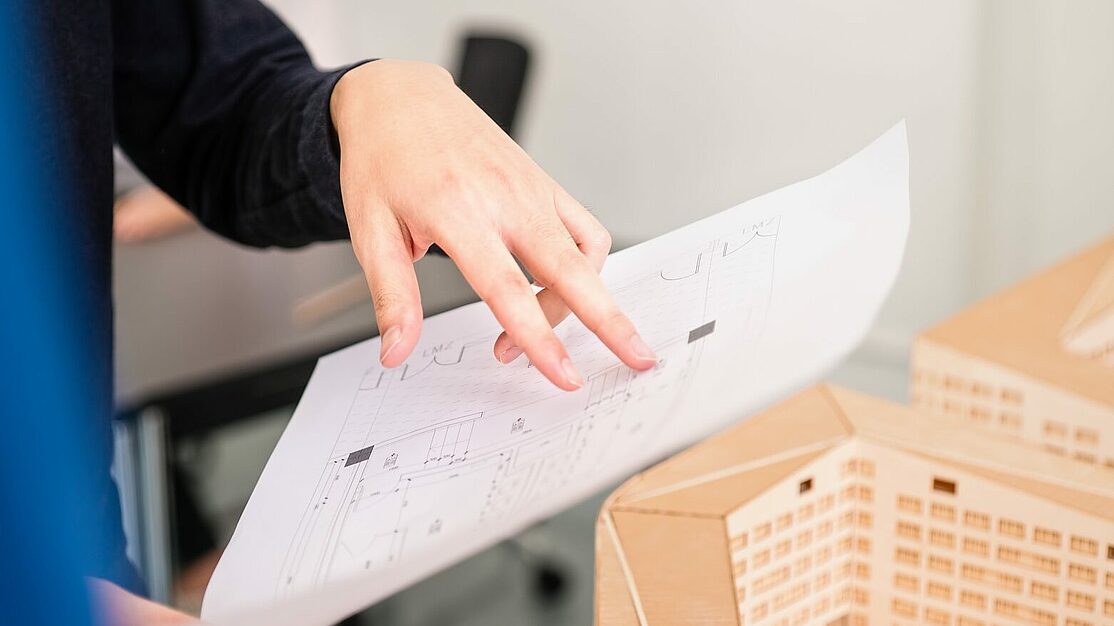 Architect reviewing technical drawings